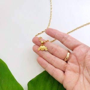 Gold chain necklace with winged heart pendant